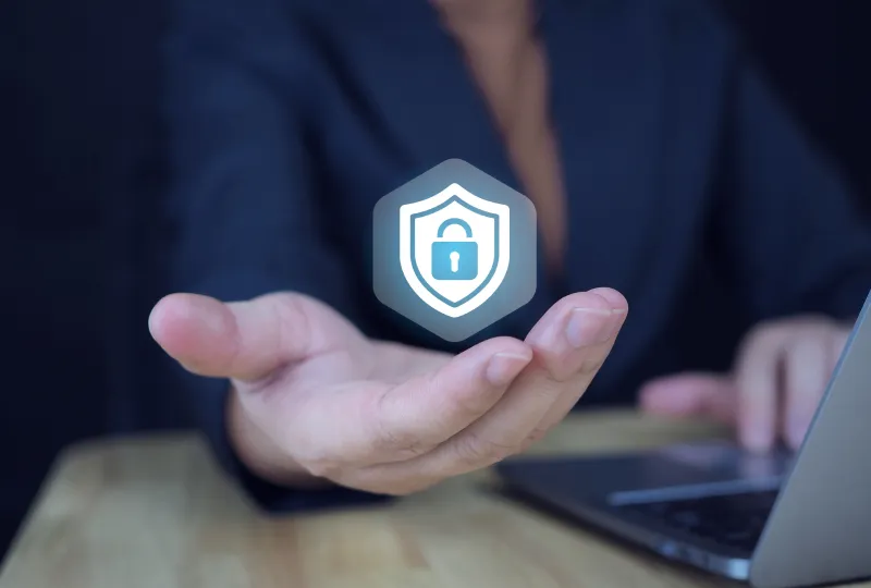 A person holding their hand out with an image of a shield on it.